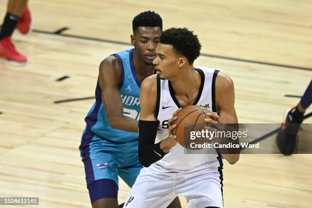 Brandon Miller of the Charlotte Hornets defends against Victor Wembanyama of the San Antonio Spurs during the fourth quarter at the Thomas & Mack...