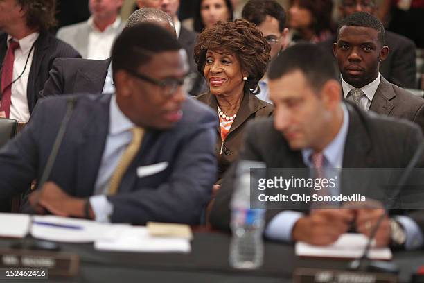 Rep. Maxine Waters smiles before the start of a rare open House Committee on Ethics hearing in the Longworth House Office Building on Capitol Hill...