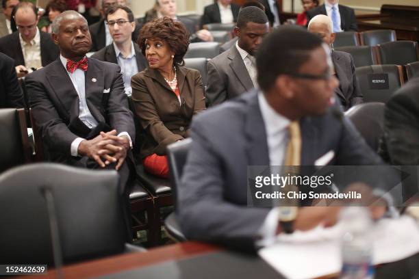 Rep. Maxine Waters , her husband Sidney Williams and her grandson and Chief of Staff Mikael Moore wait for the start of a rare open House Committee...