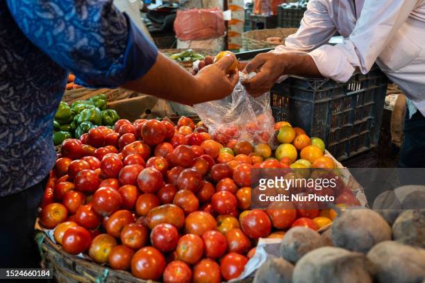 Vendor selling tomatoes in his vegetable stall, waiting for customers, in Guwahati, Assam, India on 11 July 2023. The new average retail costs for...