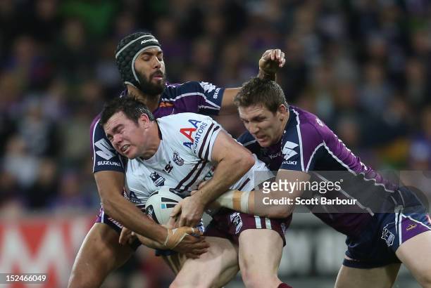 Jamie Lyon of the Sea Eagles is tackled during the NRL Preliminary Final match between the Melbourne Storm and the Manly Sea Eagles at AAMI Park on...