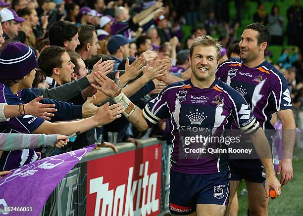 Ryan Hincliffe of the Storm high fives fans after winning the NRL Preliminary Final match between the Melbourne Storm and the Manly Sea Eagles at...