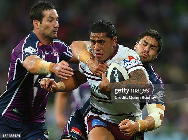 Jorge Taufua of the Sea Eagles is tackled by Jesse Bromwich and Bryan Norrie of the Storm during the NRL Preliminary Final match between the...