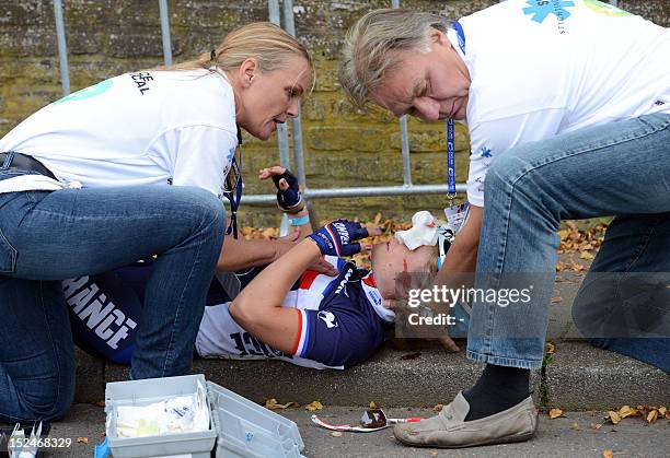 France's Eva Mottet is helped by medics after she fell during the women's Junior Road race World Championships on September 21 in Valkenburg. AFP...