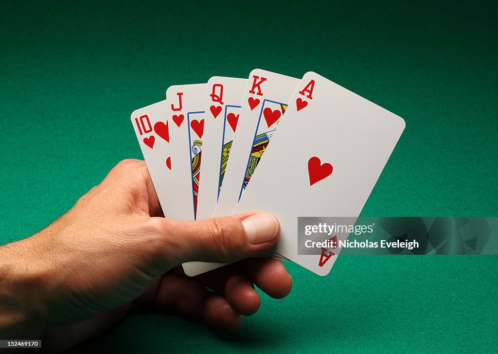 Hand holding five playing cards