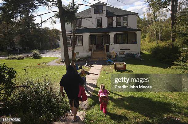 Family members greet after a school bus brought children home from the federally-funded Head Start school on September 20, 2012 in Woodbourne, New...