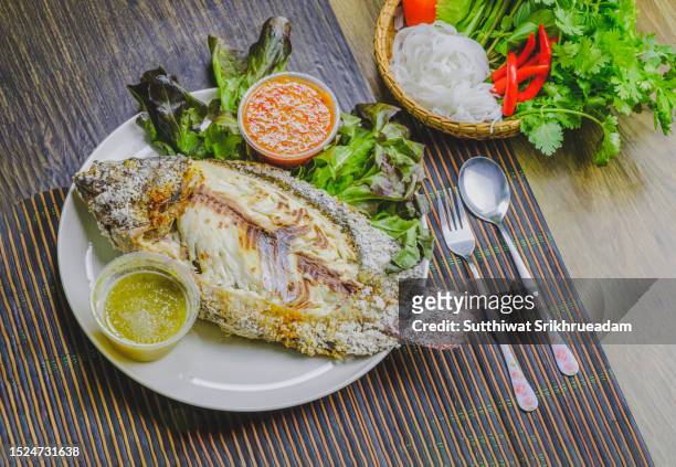 close-up of salt grilled tilapia fresh fish local food style in thailand - tilapia stock pictures, royalty-free photos & images