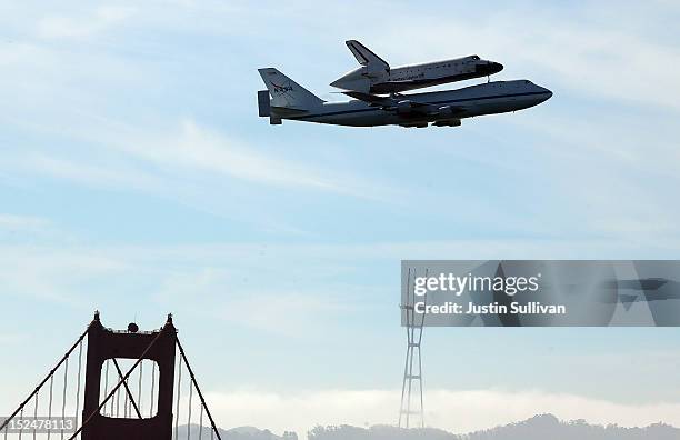 The Space Shuttle Endavour flies on top of a modified 747 jumbo jet over the Golden Gate Bridge and Sutro Tower as it travels to Los Angeles on...