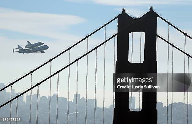 The Space Shuttle Endavour flies on top of a modified 747 jumbo jet over the Golden Gate Bridge and Sutro Tower as it travels to Los Angeles on...