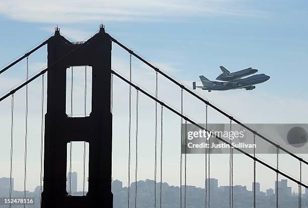 The Space Shuttle Endavour flies on top of a modified 747 jumbo jet over the Golden Gate Bridge and Sutro Tower as it travels to Los Angeles on...