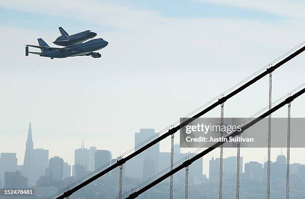 The Space Shuttle Endavour flies on top of a modified 747 jumbo jet over the Golden Gate Bridge as it travels to Los Angeles on September 21, 2012 in...