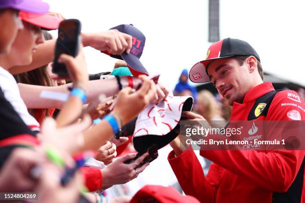 Charles Leclerc of Monaco and Ferrari greets fans as he arrives at the circuit prior to final practice ahead of the F1 Grand Prix of Great Britain at...