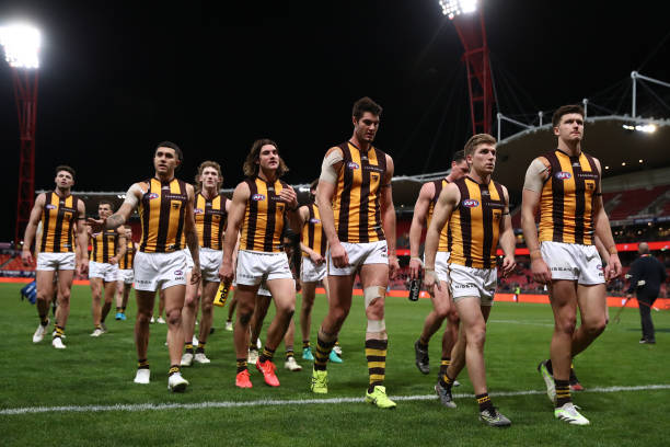 Hawks players look dejected during the round 17 AFL match between Greater Western Sydney Giants and Hawthorn Hawks at GIANTS Stadium on July 08, 2023...