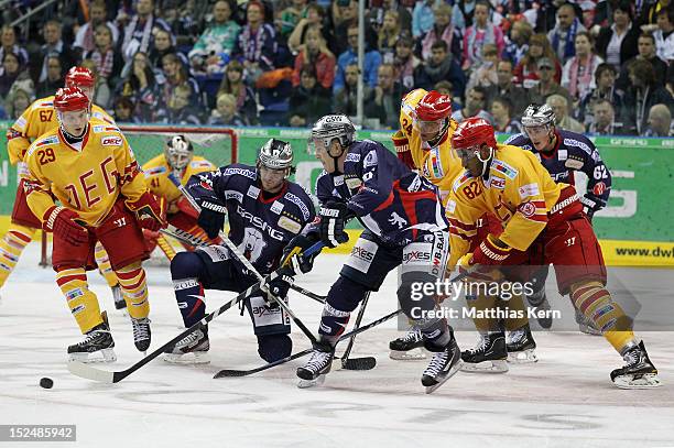 Alexander Preibisch, Darin Olver, T.J. Mulock and Drew Paris battle for the puck during the DEL match between EHC Eisbaeren Berlin and Duesseldorfer...