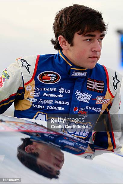 Chase Elliott, driver of the Aaron's/Hendrick Cars.com Chevrolet, climbs into his car prior to practice for the NASCAR K&N Pro Series East G-Oil 100...