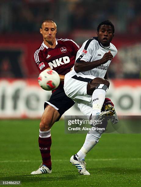 Olivier Occean of Frankfurt is challenged by Timmy Simons of Nuernberg during the Bundesliga match between 1. FC Nuernberg and Eintracht Frankfurt at...