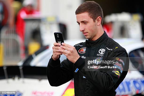 Dylan Presnell, driver of the American Mountain Rentals Toyota, takes a picture of his car in the garage prior to practice for the NASCAR K&N Pro...