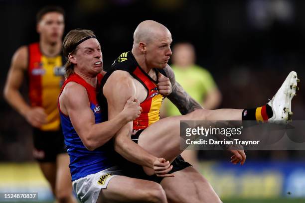 Charlie Spargo of the Demons tackles Zak Jones of the Saints during the round 17 AFL match between St Kilda Saints and Melbourne Demons at Marvel...