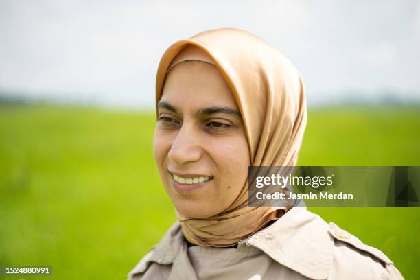 arabic woman on green meadow - veil isolated stock pictures, royalty-free photos & images