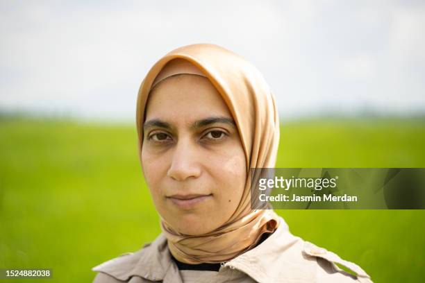 arabic woman on green meadow - veil isolated stock pictures, royalty-free photos & images