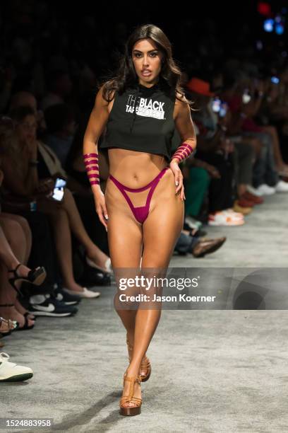 Model walks the runway wearing Black Tape Project during Miami Swim Week Powered By Art Hearts Fashion at Fontainebleau Miami Beach on July 07, 2023...