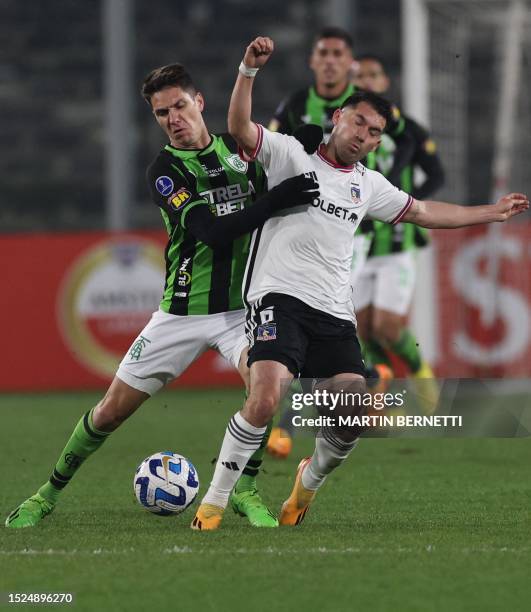 America MG's midfielder Ale and Colo-Colo's midfielder Cesar Fuentes fight for the ball during the Copa Sudamericana round of 32 knockout play-offs...