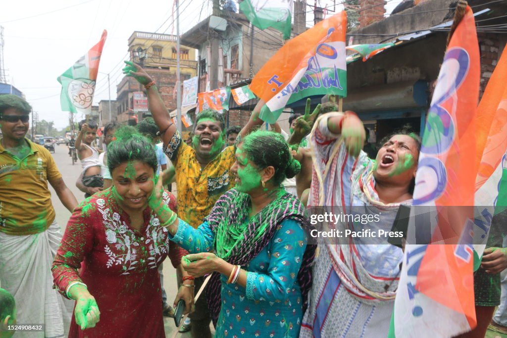 Supporters of Trinamool Congress (TMC) party celebrate the...