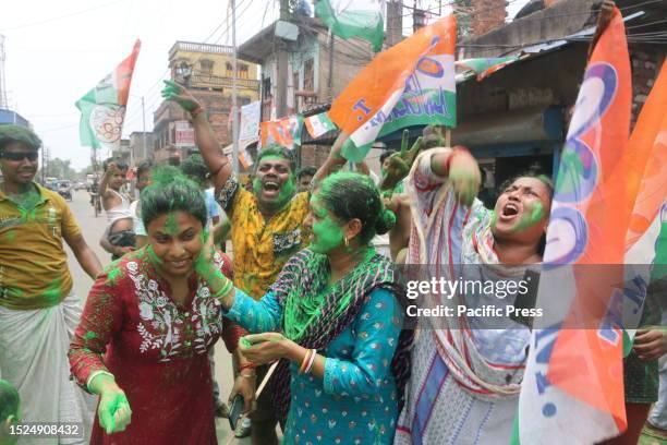 Supporters of Trinamool Congress party celebrate the party's lead during the counting of the votes of the West Bengal Panchayat polls on the...