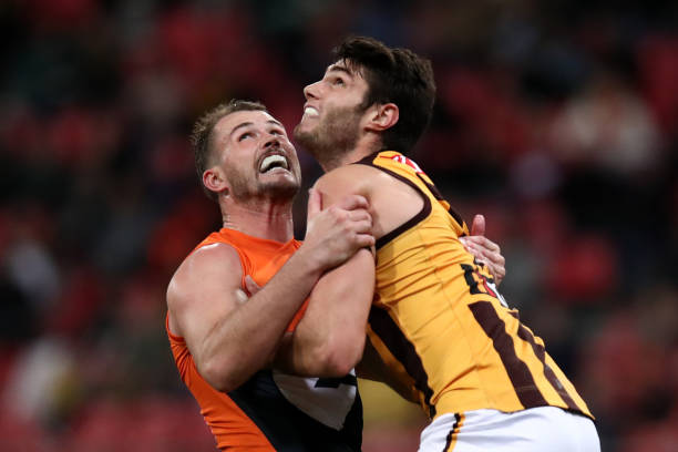 Kieren Briggs of the Giants and Ned Reeves of the Hawks compete in a ruck contest during the round 17 AFL match between Greater Western Sydney Giants...