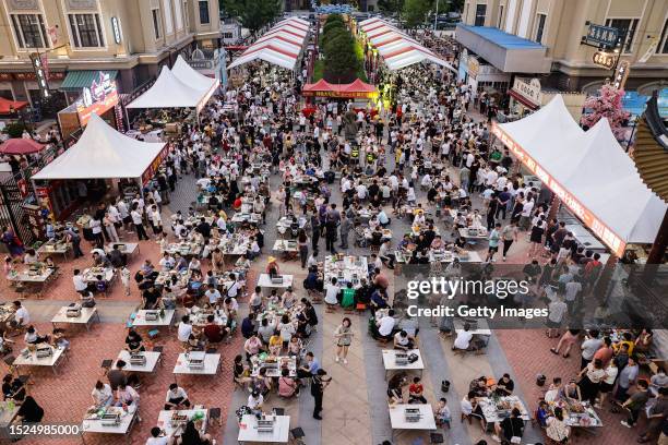 Tourists enjoy a barbecue at Hankou town during Zibo first barbecue festival Tour on July 7, 2023 in Wuhan, Hubei province, China. The organizer has...