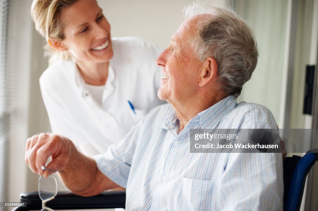 Elderly man speaking to a nurse