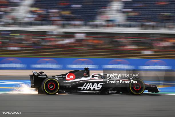 Sparks fly behind Kevin Magnussen of Denmark driving the Haas F1 VF-23 Ferrari during final practice ahead of the F1 Grand Prix of Great Britain at...