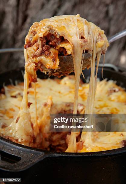 a serving of lasagna is scooped from the dish - serving lasagna stock pictures, royalty-free photos & images