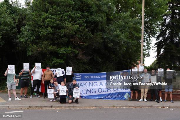 Southend United fans pose for a photo with signs in protest of Owner Ron Martin during a protest by Southend United fans outside of the house of Club...