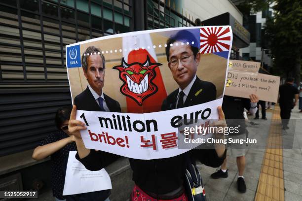 South Korean protesters participate in a rally against the Japanese government's decision to dump radioactive wastewater from the damaged Fukushima...
