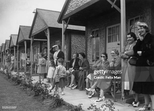 Families outside their huts at Butlin's Holiday Camp, Skegness, 1939. Original Publication: Picture Post - 193 - Holiday Camp - pub. 5th August 1939