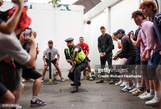 Policeman joins in a game of cricket under the Western Terrace during a rain delayed Day Three of the LV= Insurance Ashes 3rd Test Match between...