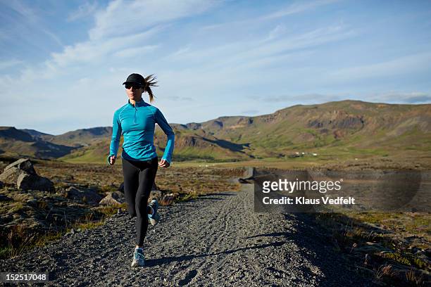 Woman running mountain trail