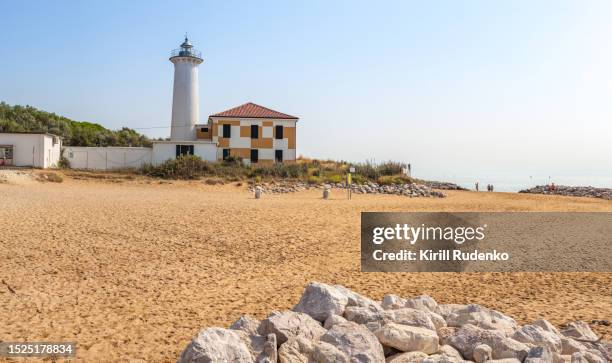 a picturesque lighthouse  stands tall on a radiant summer day - bibione stock pictures, royalty-free photos & images