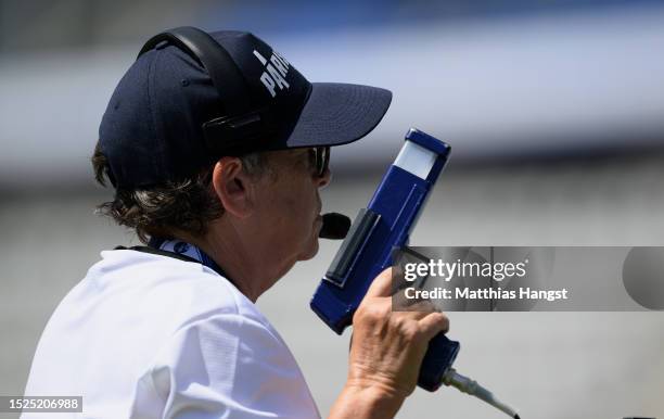 The starter holds a starting pistol during a practice session at day one of the Paris 2023 Para Athletics World Championships at Stade Charlety on...