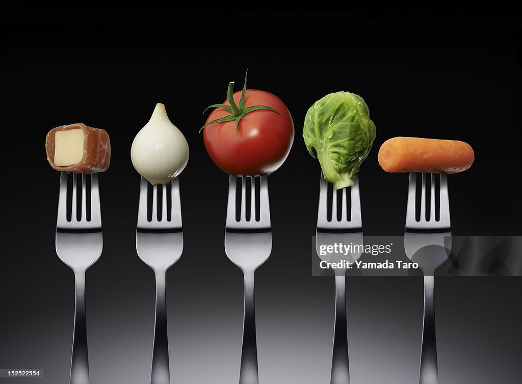 Vegetables and cheese on fork
