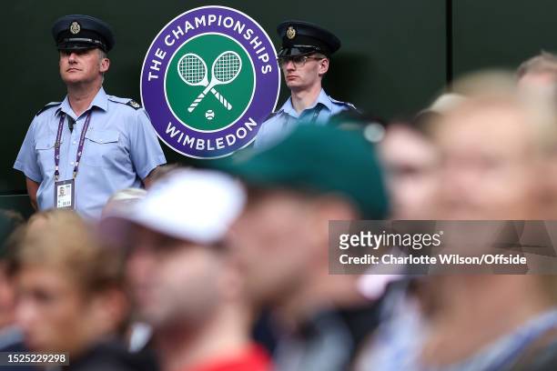 Security stand guard either sign of the Wimbledon logo during day nine of The Championships Wimbledon 2023 at All England Lawn Tennis and Croquet...