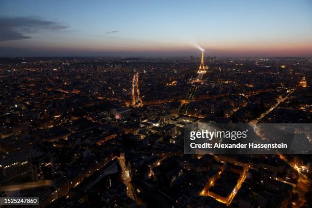 The Eiffel Tower stands illuminated after sunset on July 07, 2023 in Paris, France. Paris will host the Summer Olympics from July 26 till August 11,...