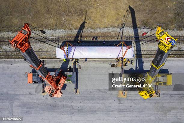 aerial top view mobile crane lifting electric diesel locomotive. - general electric stock pictures, royalty-free photos & images