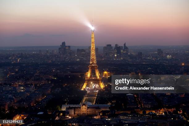 The Eiffel Tower stands illuminated after sunset on July 07, 2023 in Paris, France. Paris will host the Summer Olympics from July 26 till August 11,...