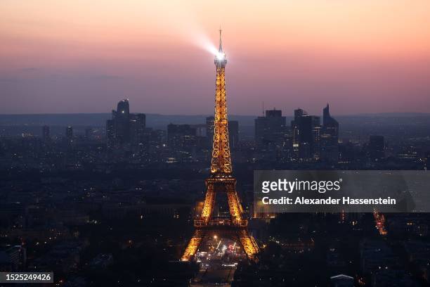 The Eiffel Tower stands illuminated after sunset on July 07, 2023 in Paris, France. Paris will host the Summer Olympics from July 26 till August 11,...
