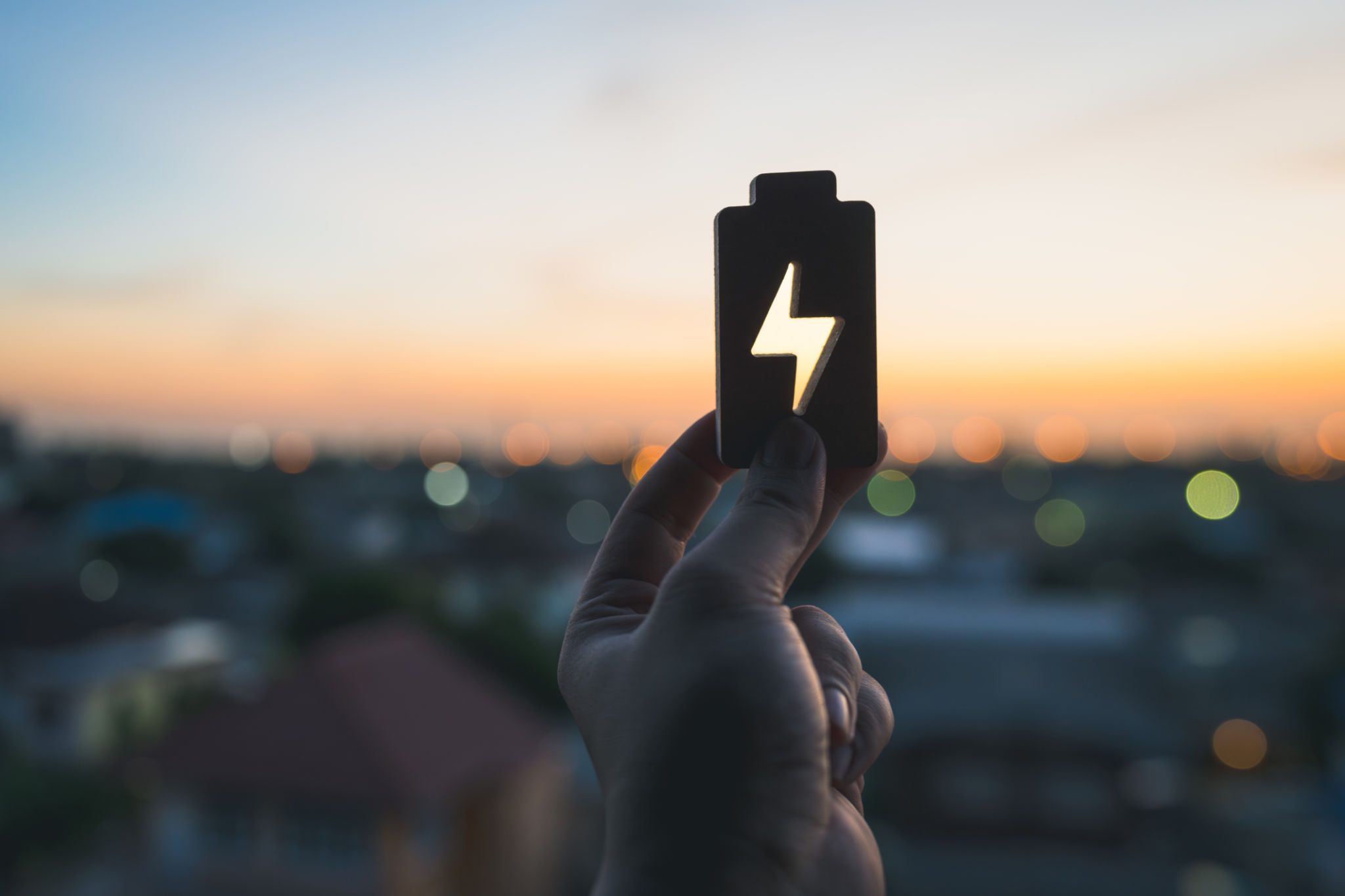 Technology battery high power electric energy with a connected charging cable. Battery to electric cars and mobile devices with clean electric, Green renewable energy battery storage future. Technology battery high power electric energy with a connected charging cable. Battery to electric cars and mobile devices with clean electric, Green renewable energy battery storage future.