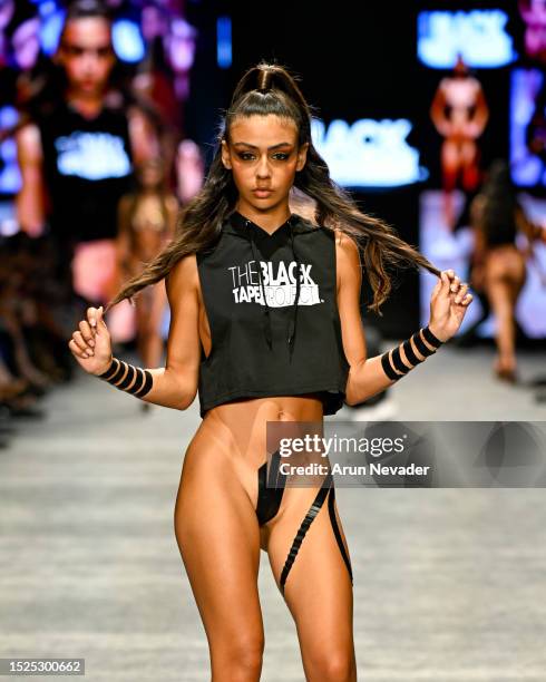 Model walks the runway wearing Black Tape Project during Miami Swim Week Powered by Art Hearts Fashion at Fontainebleau Hotel on July 07, 2023 in...