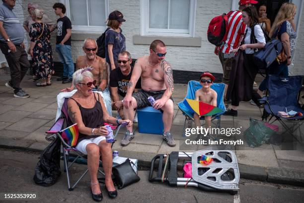 Family sits on the roadside as they listen to the colliery bands play during the 137th Durham Miners Gala on July 08, 2023 in Durham, England. Hosted...