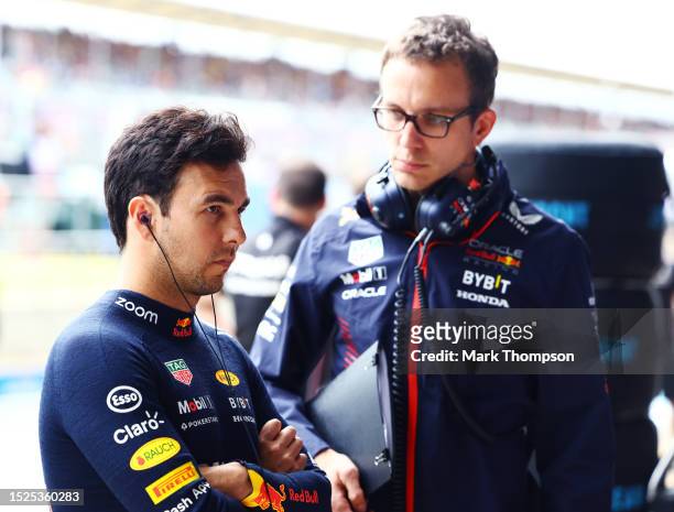 Sergio Perez of Mexico and Oracle Red Bull Racing talks with race engineer Hugh Bird in the garage during qualifying ahead of the F1 Grand Prix of...